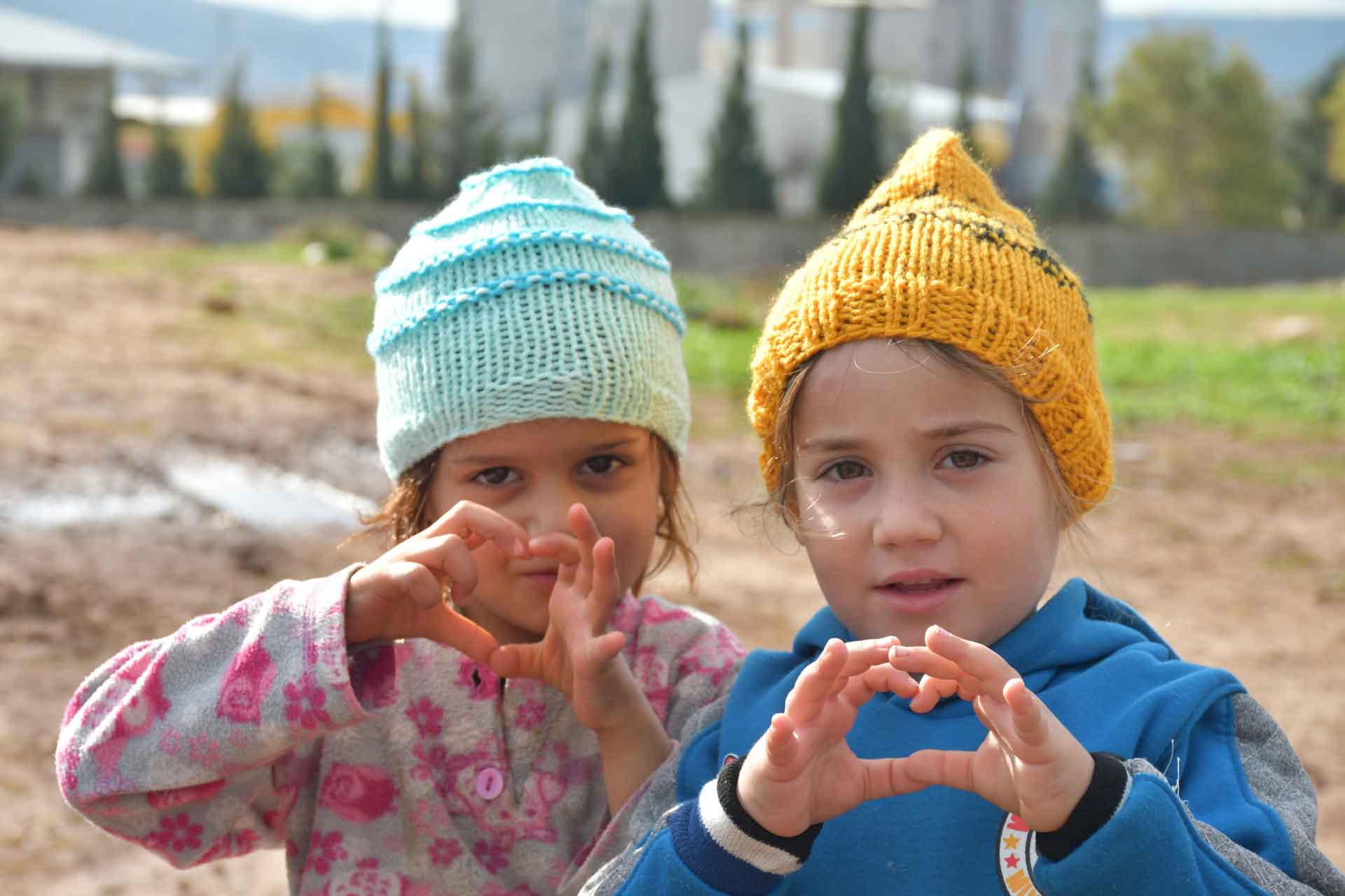 Zwei Mädchen im Libanon formen ein Herz mit ihren Händen.
